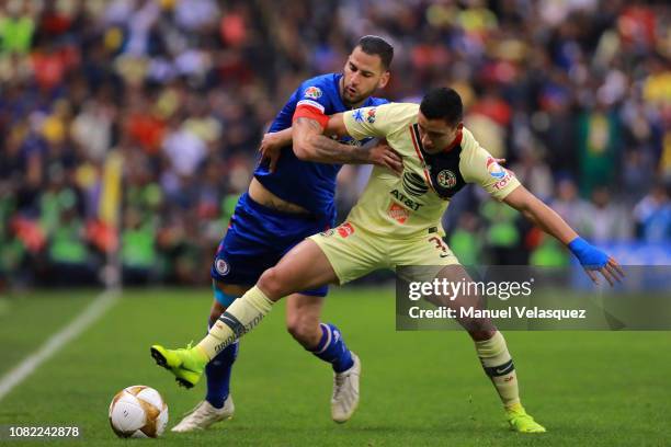 Jorge Sanchez of America struggles for the ball against Edgar Mendez of Cruz Azul during the final first leg match between America and Cruz Azul as...