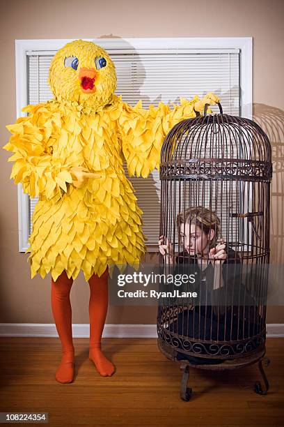 role reversal; big yellow bird and pet human - big bird stockfoto's en -beelden