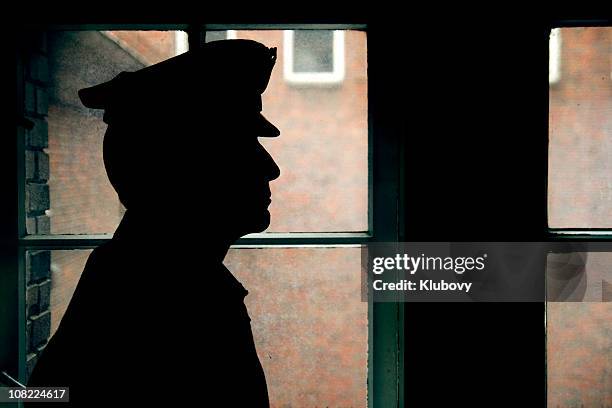 silhouette of a prison/police warden - police hat stock pictures, royalty-free photos & images