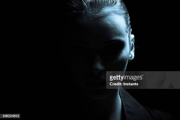 portrait of young woman, low key - head silhouette stock pictures, royalty-free photos & images