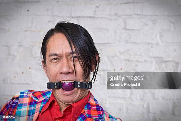 crazy asiatischen mann mit ball knebel - kinky stock-fotos und bilder