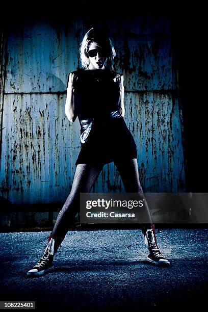 portrait of young woman posing against grunge background, low key - legs spread woman bildbanksfoton och bilder