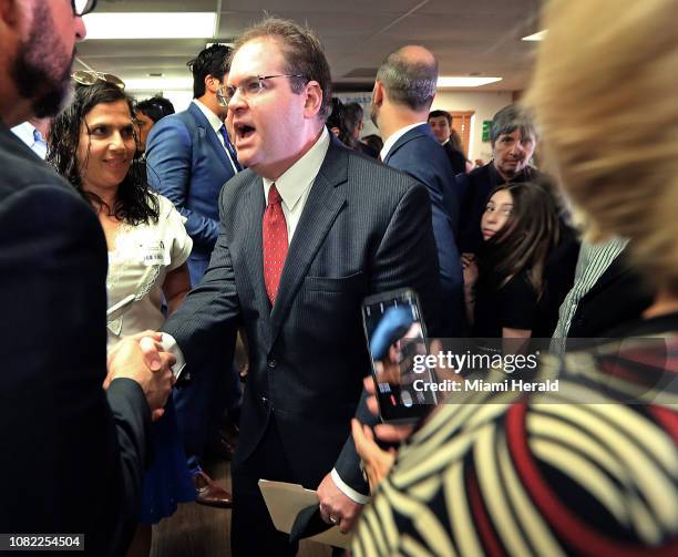 On Monday, Jan. 14 Judge Robert Luck, center, is congratulated by well-wishers while standing next to his family inside the media center at Check...