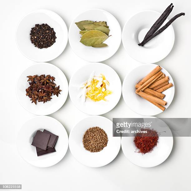 ingredienti alimentari e spezie organizzato su bianco piastre - grano di pepe nero foto e immagini stock