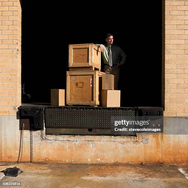 warehouse loading dock with crates - shipping crate stock pictures, royalty-free photos & images