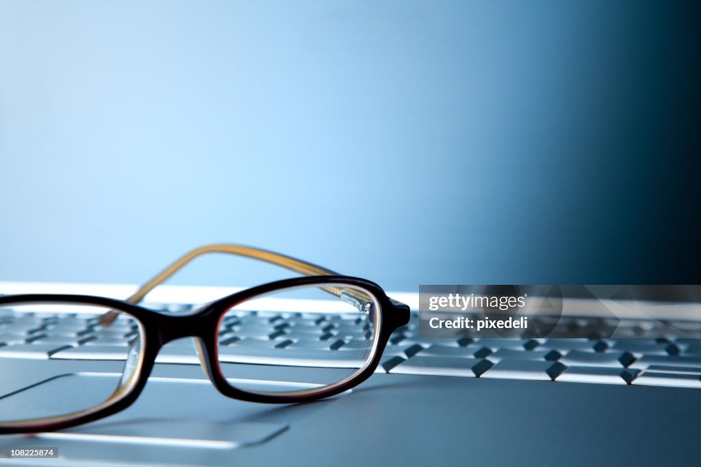 Eye Glasses Sitting on Top of Laptop