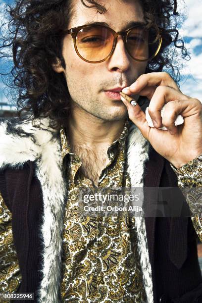 portrait of hippie man smoking marijuana cigarette - smoking issues stock pictures, royalty-free photos & images