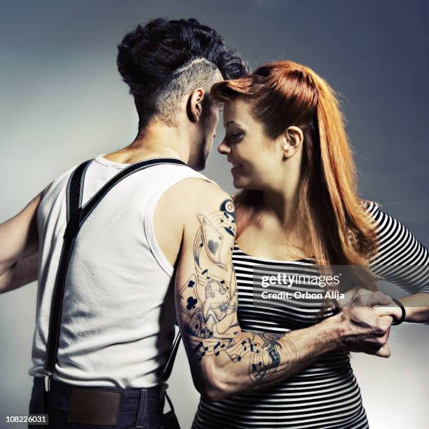 rockabilly man and woman holding hands dancing - rockabilly bildbanksfoton och bilder