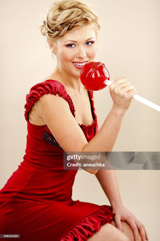 Young Woman Holding Giant Red Lollipop