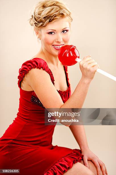 young woman holding giant red lollipop - 2000 2009 stock pictures, royalty-free photos & images