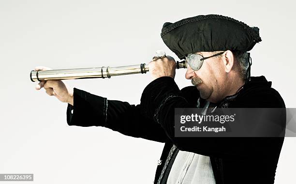 pirate looking through telescope - pirate hat stock pictures, royalty-free photos & images