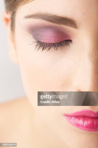 half of woman's face with closed eye wearing make-up - midsagittale vlak stockfoto's en -beelden