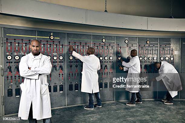scientist working with switchboard in control room - mission control stock pictures, royalty-free photos & images