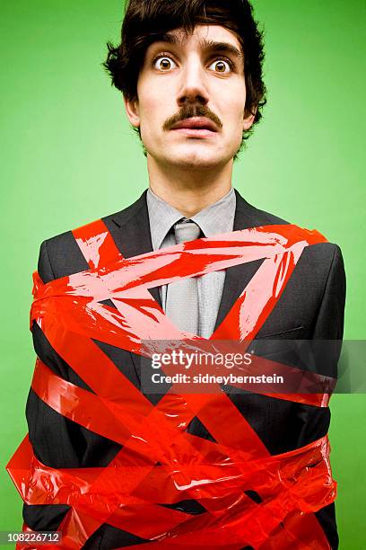 businessman tied up in red tape - administrative professional stock pictures, royalty-free photos & images