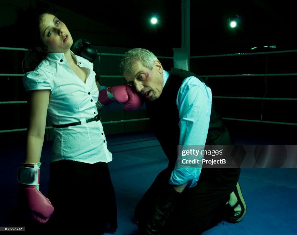 Businessman and Woman in Boxing Ring