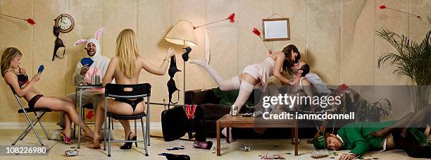 holiday party with leprechaun, easter bunny and cupid - easter bunny man stockfoto's en -beelden