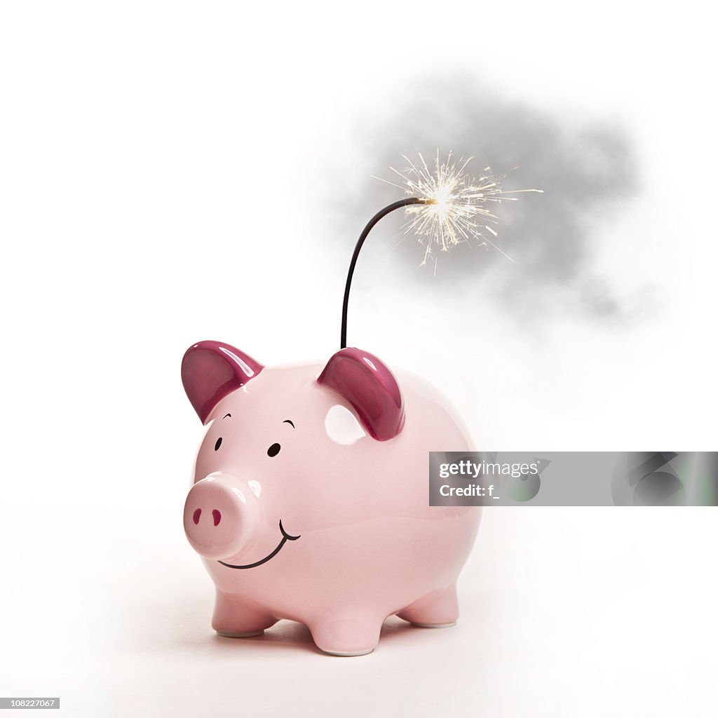 Piggy Bank with Lit Bomb Fuse, Isolated on White