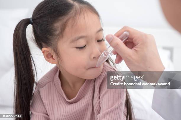 small sick girl taking medicine - syrup stock pictures, royalty-free photos & images