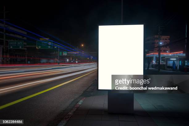 blank billboard on city street at night. outdoor advertising - poster mockup stock pictures, royalty-free photos & images