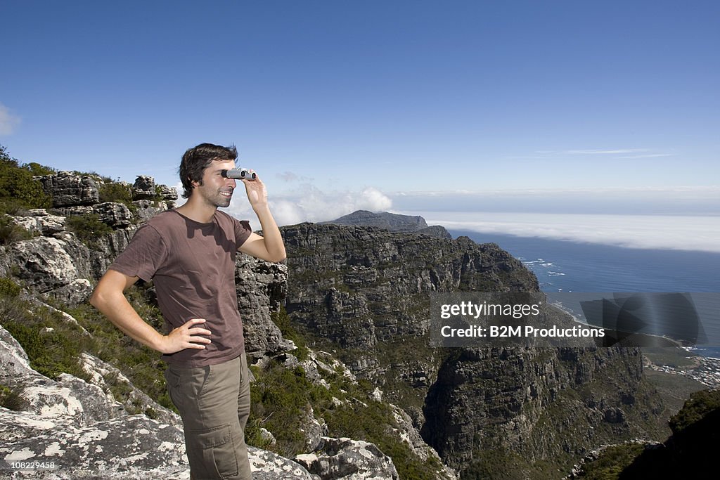 Man looking through binoculars