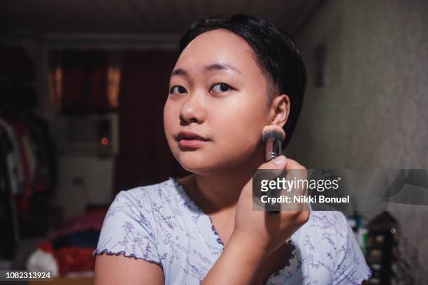 young woman applying makeup - showus makeup stock pictures, royalty-free photos & images