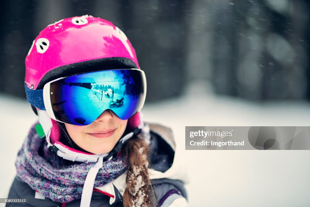 Portrait of a teenage girl skiing