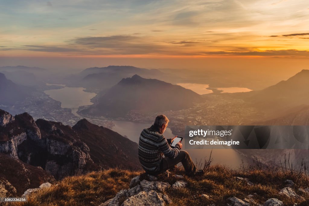 Man hiker solo on the mountain during golden hour