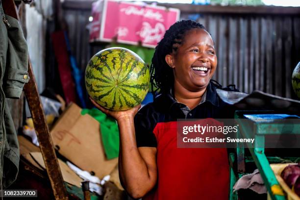 woman laughing at her place of business - african market stock pictures, royalty-free photos & images