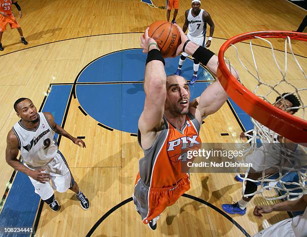 Marcin Gortat of the Phoenix Suns dunks against Rashard Lewis of the Washington Wizards at the Verizon Center on January 21, 2011 in Washington, DC....