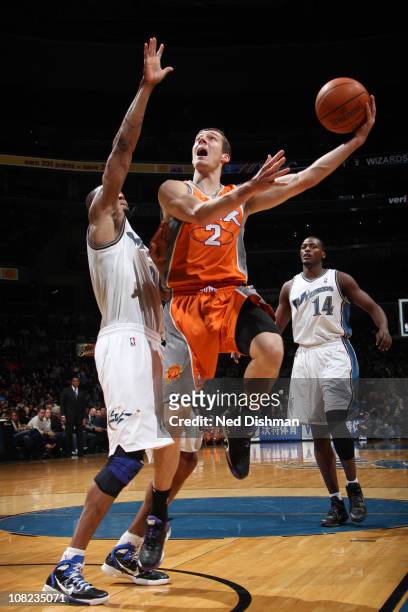 Goran Dragic of the Phoenix Suns shoots against Rashard Lewis of the Washington Wizards at the Verizon Center on January 21, 2011 in Washington, DC....