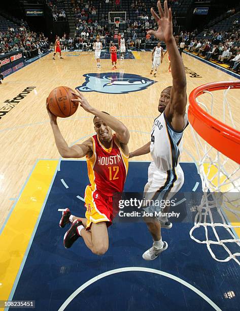 Kevin Martin of the Houston Rockets shoots a layup against Sam Young of the Memphis Grizzlies on January 21, 2011 at FedExForum in Memphis,...