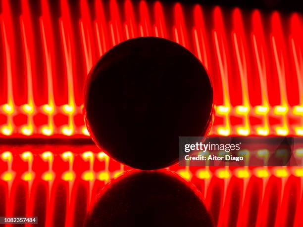 ball in the shape of earth or world map on reflective surface and red lines background. light painting. conceptual nature - mapa múndi imagens e fotografias de stock