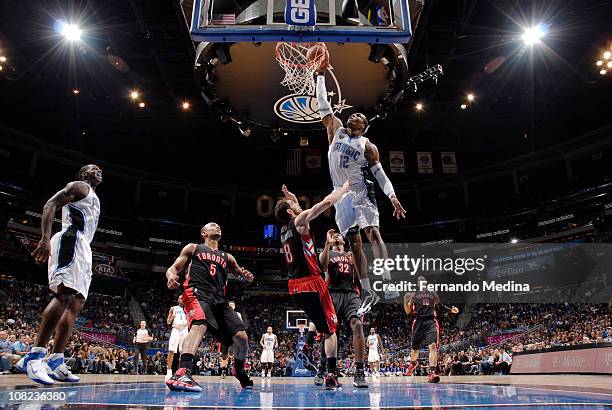 Dwight Howard of the Orlando Magic dunks against Jose Calderon of the Toronto Raptors on January 21, 2011 at the Amway Center in Orlando, Florida....