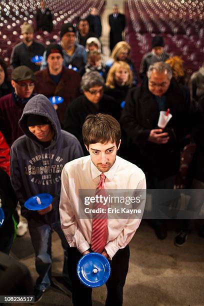 Michael McHugh prays with others in support of U.S. Rep. Gabrielle Giffords at a candlelight vigil at the Miller Outdoor Theatre on January 21, 2011...