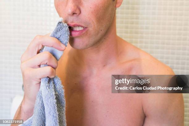 man with herpes simplex virus on his lips drying his face with a towel - genital herpes stock pictures, royalty-free photos & images