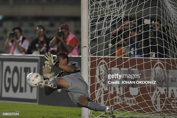 Costa Rican goalkeeper Daniel Cambronero fails to stop a ball during a penalty shot by Panamanian Blas Perez during their semi-final match of the...
