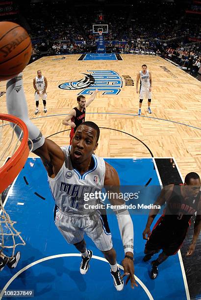 Dwight Howard of the Orlando Magic dunks against Joey Dorsey of the Toronto Raptors on January 21, 2011 at the Amway Center in Orlando, Florida. NOTE...