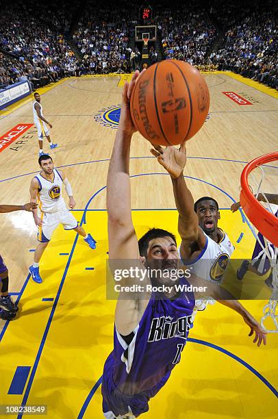 Omri Casspi of the Sacramento Kings dunks the ball against Ekpe Udoh of the Golden State Warriors on January 21, 2011 at Oracle Arena in Oakland,...