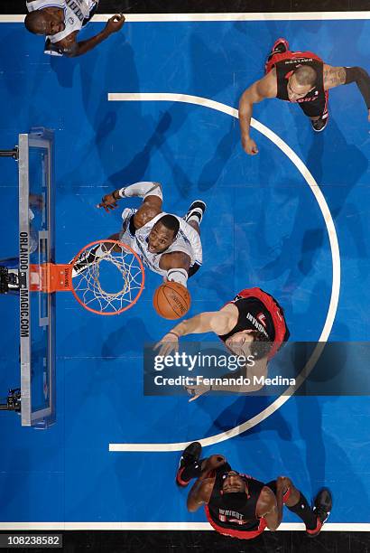 Dwight Howard of the Orlando Magic rebounds against Andrea Bargnani of the Toronto Raptors on January 21, 2011 at the Amway Center in Orlando,...