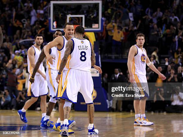 Monta Ellis is congratulated by Stephen Curry of the Golden State Warriors after Ellis made a shot with less than a second left in regulation to send...