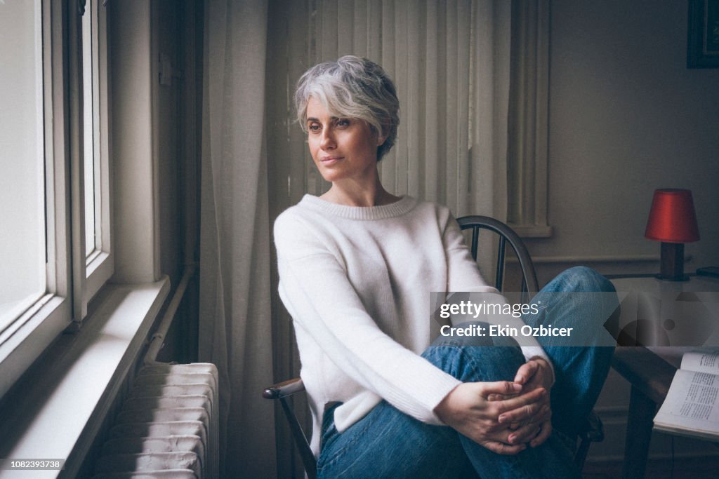 Woman enjoying herself by the window