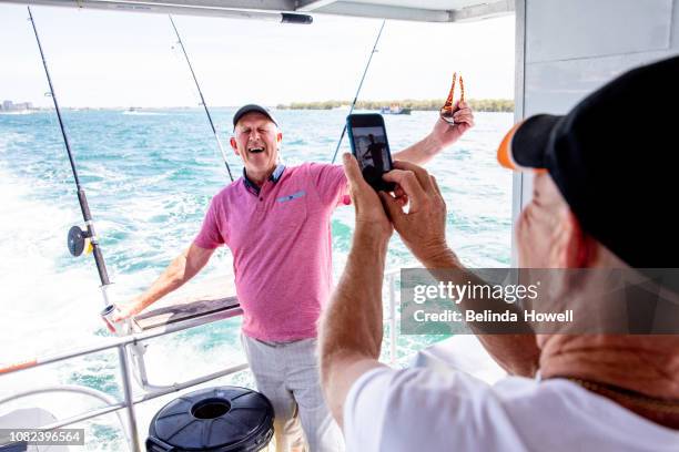 australian family spends the weekend with grandparents on a pontoon boat on the gold coast broadwater. - pontoon boat stock pictures, royalty-free photos & images