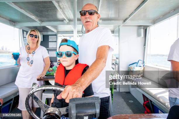 australian family spends the weekend with grandparents on a pontoon boat on the gold coast broadwater. - pontoon boat stock pictures, royalty-free photos & images