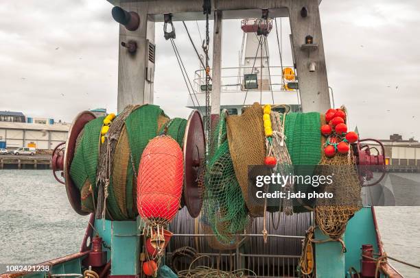 steel pulleys of a ship with fishing nets and buoys - winch bildbanksfoton och bilder