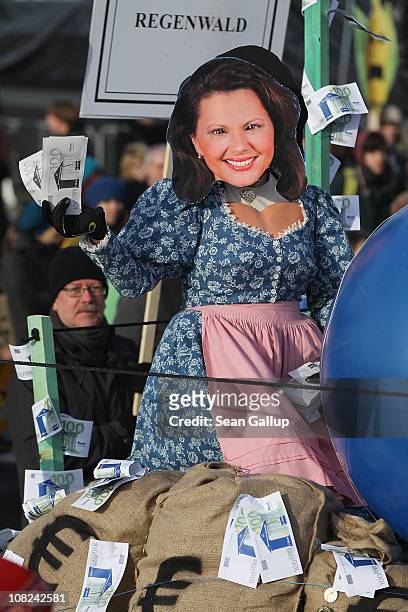 An activist on dressed as an effigy of German Agriculture and Consumer Protection Minister Ilse Aigner joins a march against the agricultural...
