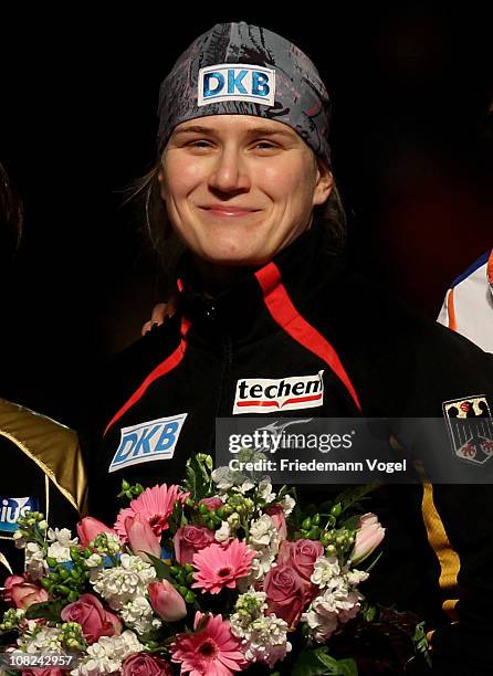 Jenny Wolf of Germany celebrates on the podium after winning the 500m race during the first day of the ISU World sprint speed skating Championships...