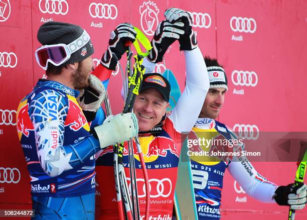 Bode Miller of USA , Didier Cuche of Switzerland and Adrien Theaux of France pose on the podium after winning the Hahnenkamm race on January 22, 2011...