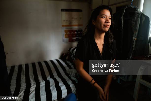 young filipino woman sitting, contemplating and meditating - filipino stock pictures, royalty-free photos & images