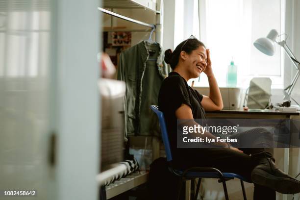 young filipino student sitting in her dorm room - filipino woman fotografías e imágenes de stock