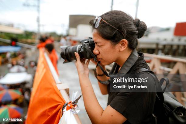 young filipino student photojournalist taking photographs - journalist stock-fotos und bilder